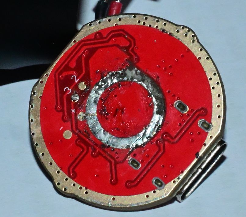 The results of attempting to remove the spring with a soldering iron, featuring some missing pad